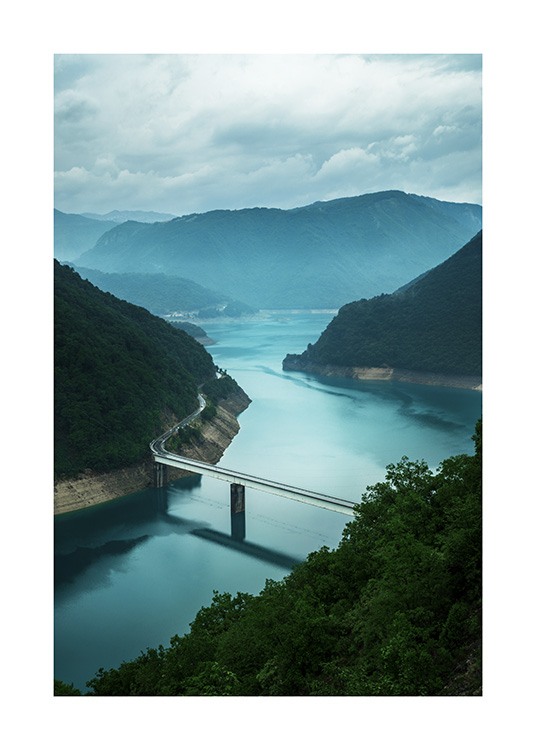  - Fotografía de un motivo de la naturaleza; puente sobre el río Naeroyfjord en Noruega, con montañas y nubes al fondo.