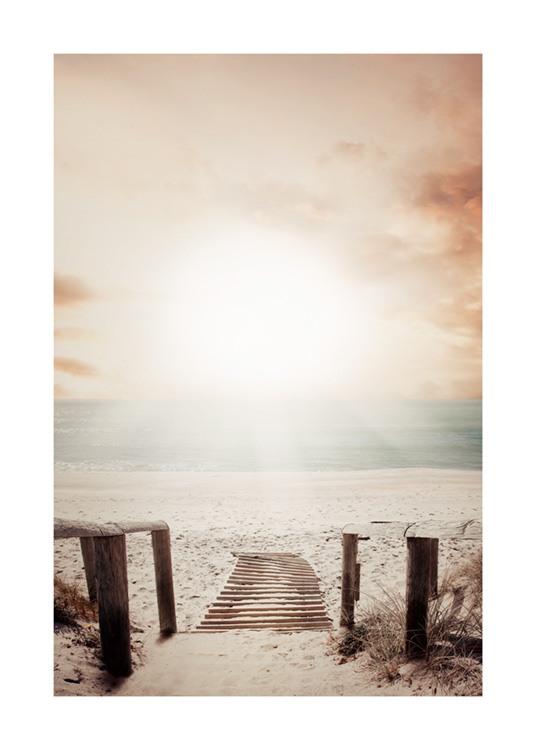  – Fotografía de una pasarela de madera que conduce a una playa Iluminada por el sol del atardecer.