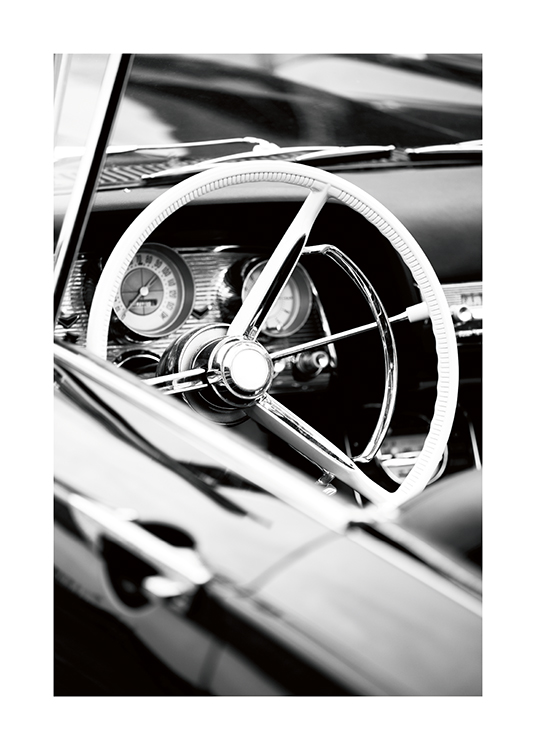  – Fotografía en blanco y negro del volante y el tablero de un descapotable de estilo vintage.
